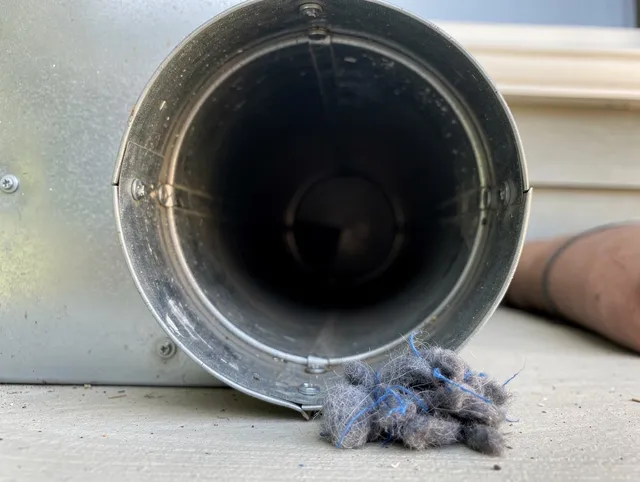 Rancho Santa Margarita Dryer Vent Cleaning technician using specialized equipment to clear severe dryer vent blockage in Rancho Santa Margarita